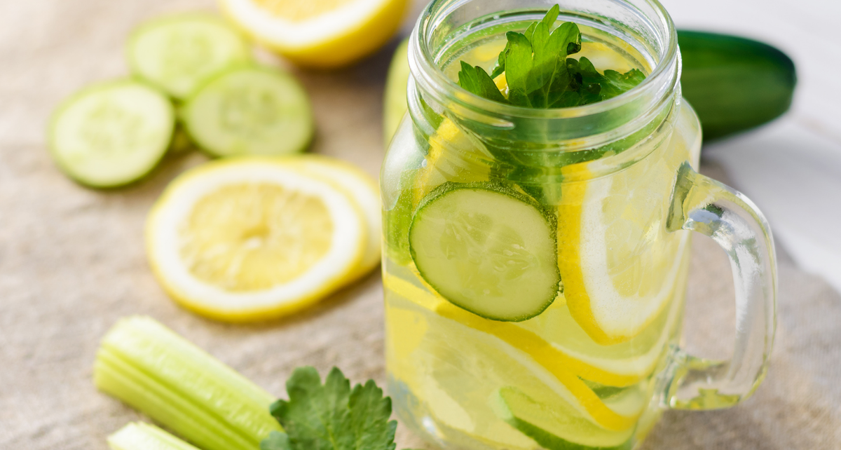 Glass jar of cut lemons, limes and mint