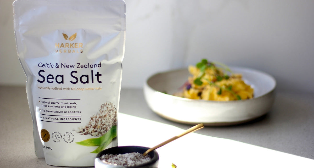 kitchen bench showing bag of sea salt next to a home cooked meal