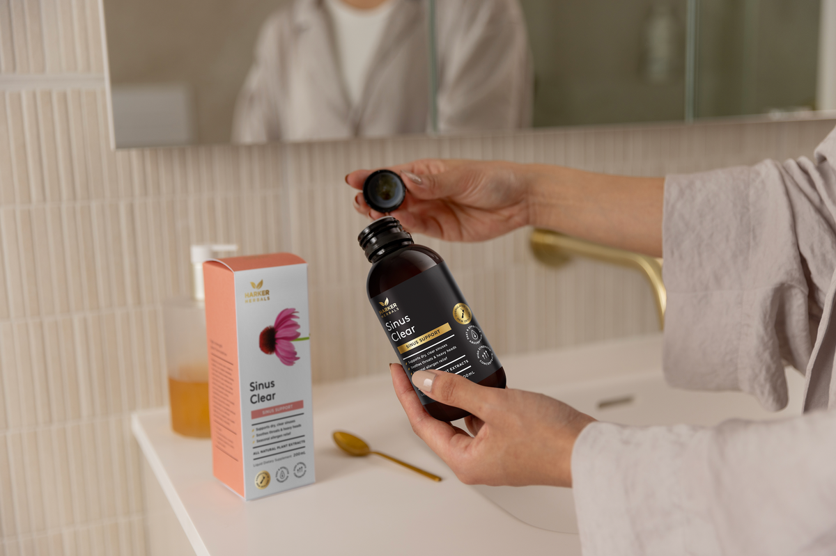 Sinus Clear being held in a bathroom by lady in robe
